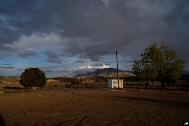 A rainbow is seen in the distance from the closed Chilchinbeto Church of the Nazarene in Chilchinbeto, Arizona, on the Navajo reservation, April 21, 2020. About 40,000 homes in Indian Country in Arizona don't have traditional addresses.